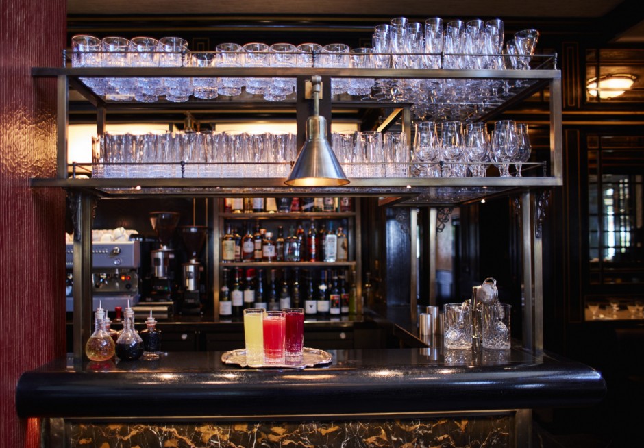 Bar with brass overbar unit. Front faced with marble surrounded by brass trim